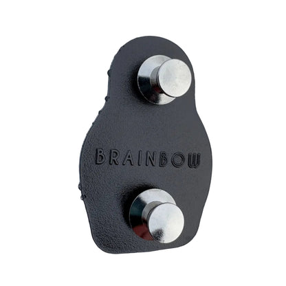 Reverse side of a black metal pin with raised BRAINBOW branding and two locking pin backs.